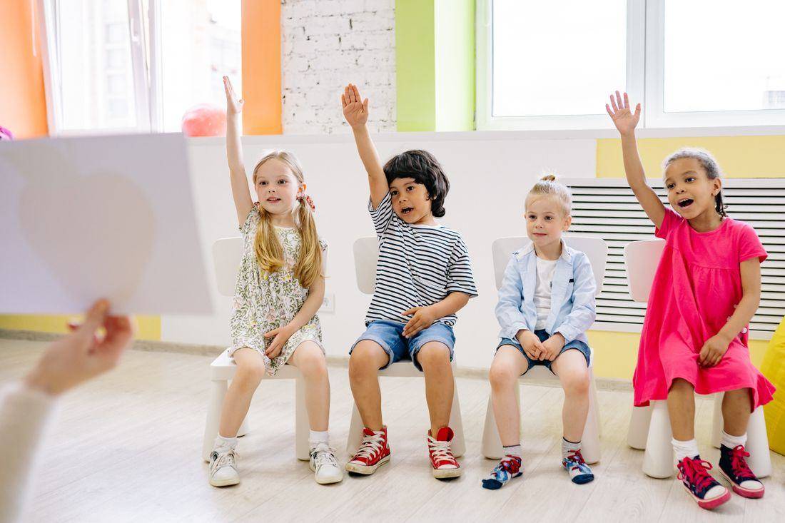 Children raising their hands
