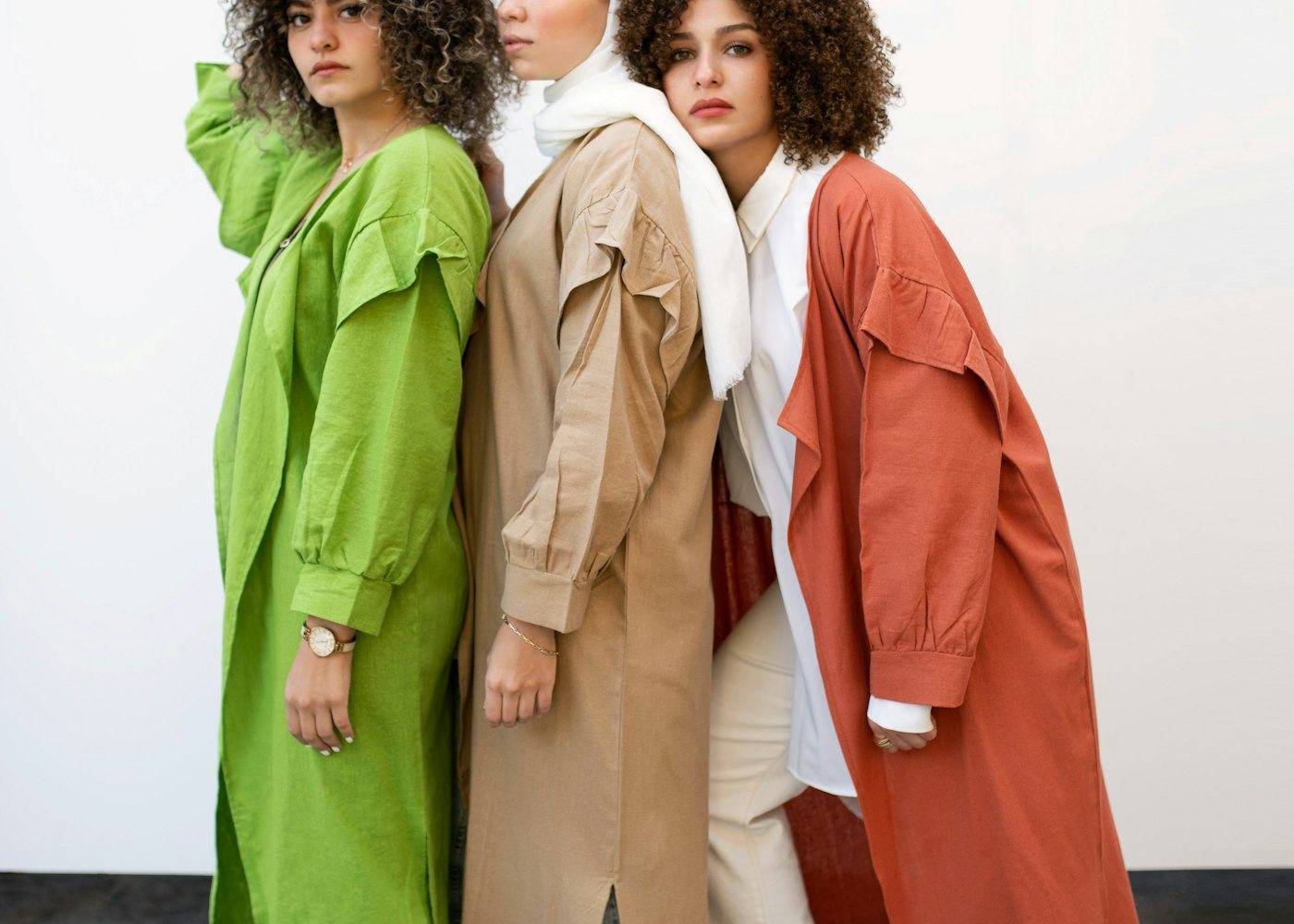 Three models in linen coats