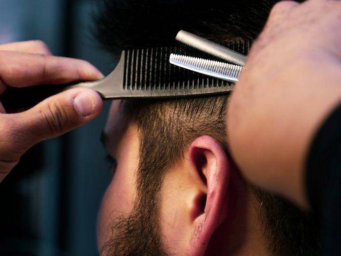 Barber trimming with shears