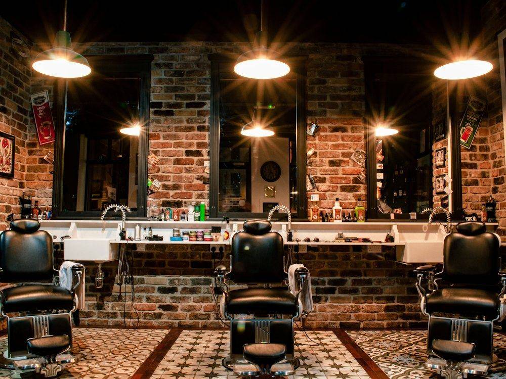 Barbershop interior with leather chairs and brick walls