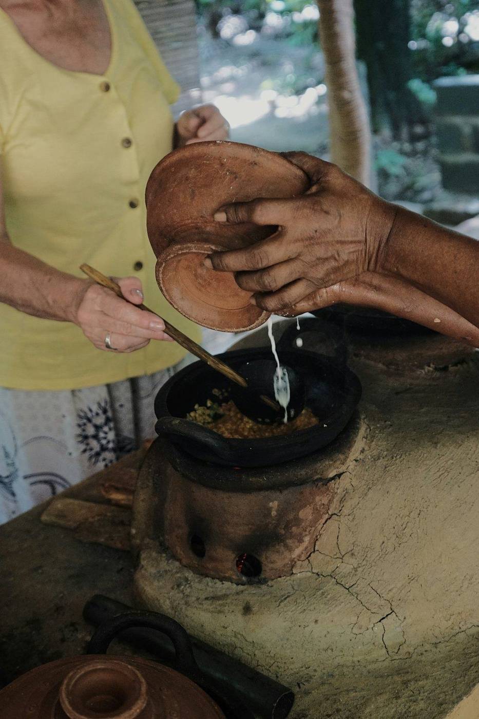 Hands grinding spices on a stone