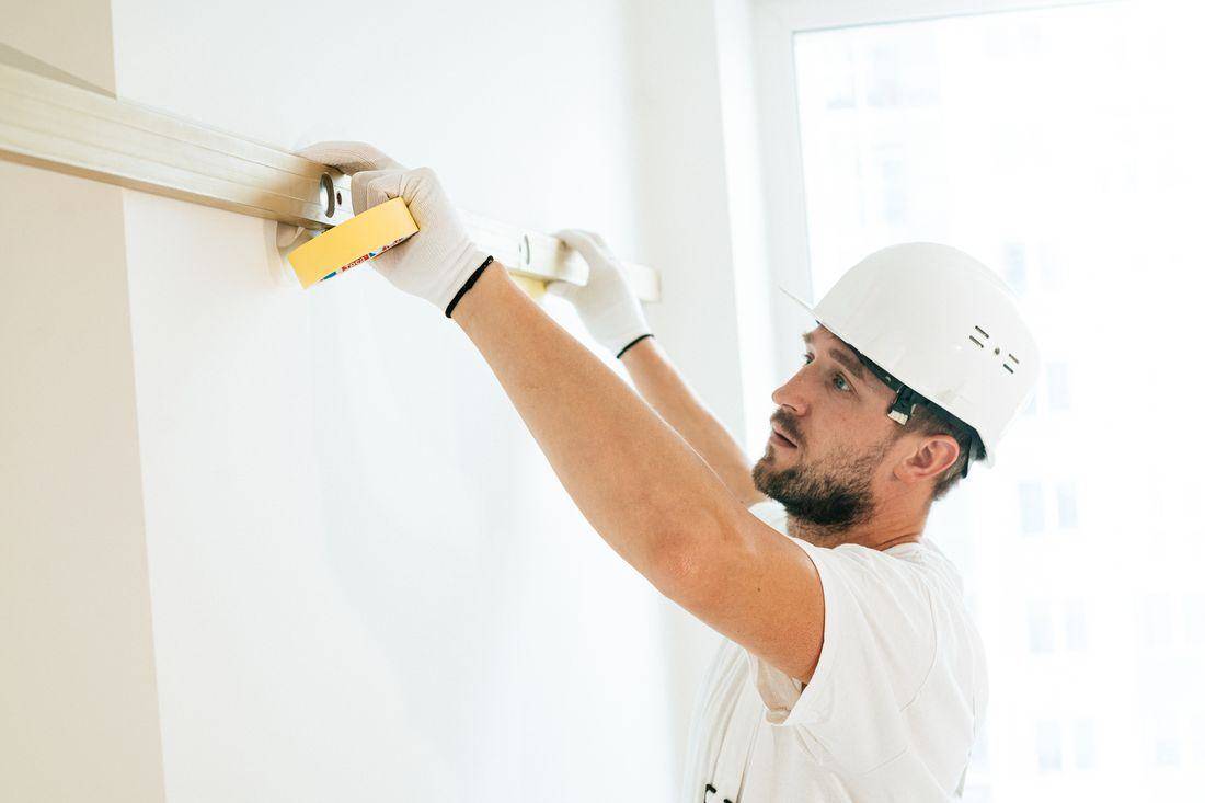 Builder checking a wall with a spirit level